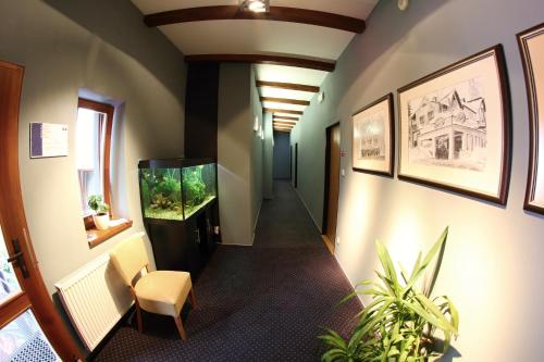 a hallway in an office with a fish tank on the wall at Apart Hotel Jablonec in Jablonec nad Nisou