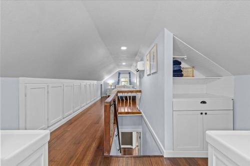 a hallway with white cabinets and a staircase in a house at Blue Door Breeze in Coeur d'Alene