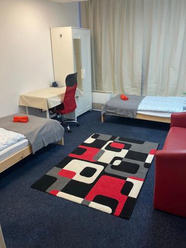 a room with two beds and a rug on the floor at Viola Hostel in Budapest