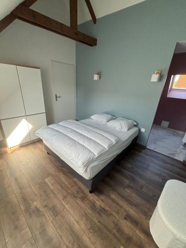 a bedroom with a large bed in a room at Chez Julie & Yvon in Le Portel