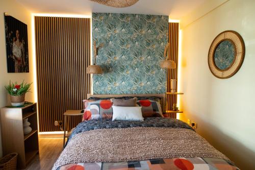 a bedroom with a bed and a blue wall at ApArt Gallery Apartment 2, Stylish 3- Bed , Free Parking ,Sleeps 6 in Bedford