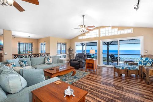 a living room with a couch and a table at Honu O Kai (Turtle of the Sea) in Kailua-Kona