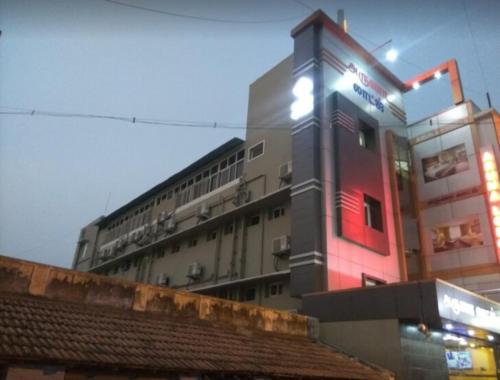 a building with a light on the side of it at PRM Aruna Lodge in Erode