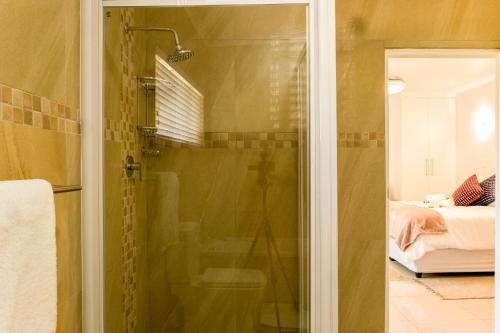 a shower with a glass door in a bathroom at Valhalla on Knelsby in Hillcrest