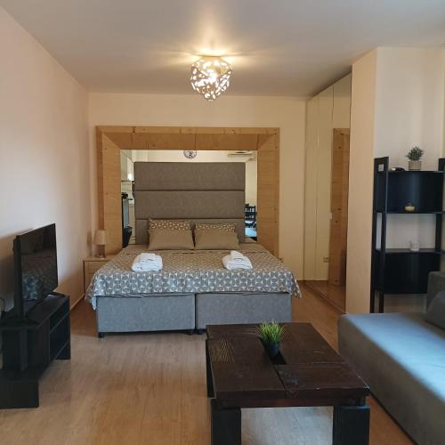 a bedroom with a bed and a living room at Atlantic in Pomorie