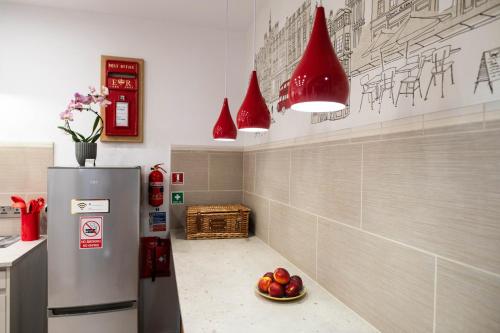 a kitchen with a refrigerator and a bowl of fruit at ApArt Gallery Apartment 2, Stylish 3- Bed , Free Parking ,Sleeps 6 in Bedford