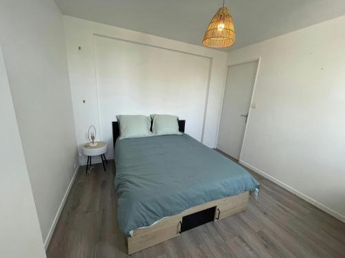 a bedroom with a bed and a table and a lamp at Bright Spacious Flat • 5 Guests • Near Tram in Brest