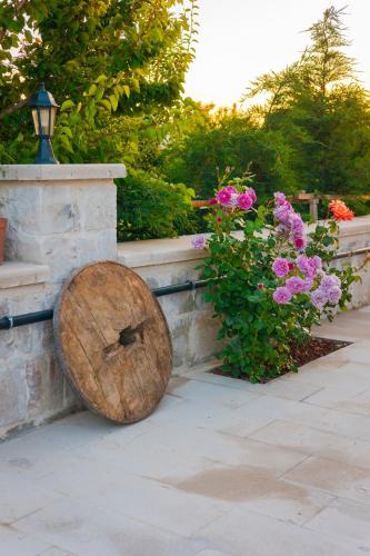 a log sitting on the ground next to some flowers at Nest Cappadocia Hotel in Uchisar