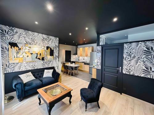a living room with a couch and a table at LEtape Prestige Hyper-Centre Calme in Reims