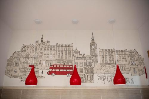 a wall with a drawing of a bus and red objects at ApArt Gallery Apartment 2, Stylish 3- Bed , Free Parking ,Sleeps 6 in Bedford