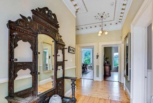 an ornate mirror in the hallway of a home at Fabulous 6 Bedroom Victorian Period House in Derry Londonderry