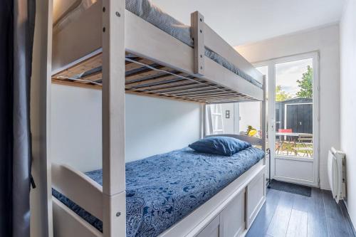 - une chambre avec 2 lits superposés et un lit bleu dans l'établissement Montmorency Garden Billiards near Paris, à Enghien-les-Bains