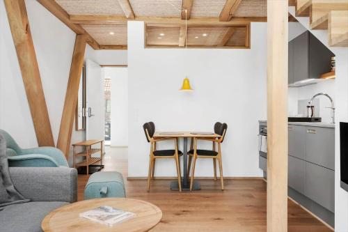 a kitchen and living room with a table and chairs at 1171-Ringkobing-Jagtvej-34-C-lejl-2 in Ringkøbing