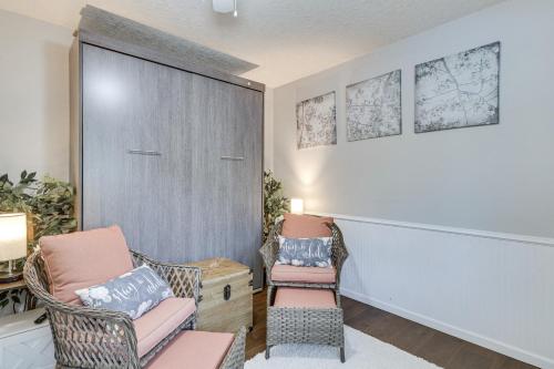 a living room with two chairs and a door at 2 Mi to Dtwn Forest Grove Quiet Studio with Yard in Forest Grove