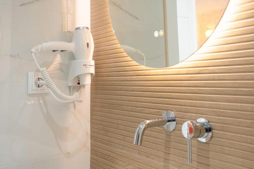 a bathroom with a shower with a mirror at Sónia's Studio in Nazaré