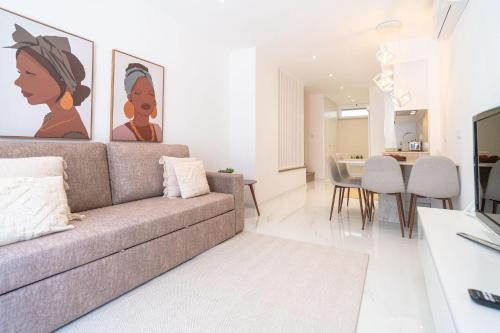a living room with a couch and a dining room at Sónia's Studio in Nazaré
