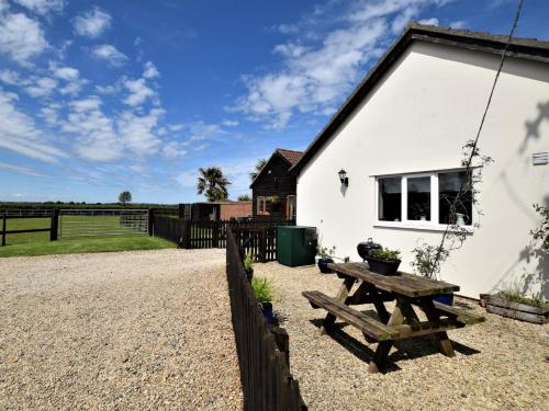 a white house with a picnic table in front of it at 1 bed in Bradford-on-Avon 58771 in Erlestoke