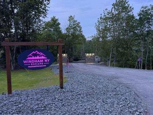 a sign for a wildlife park with a gravel road at Tiny Cabin #4 by Windham NY Escape 'Cabin Comfort' in Hensonville