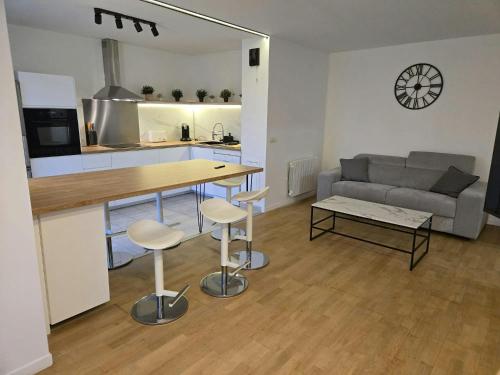 a kitchen and living room with a table and a couch at The Blue Sky Haven 2 - 5min to Disneyland in Serris