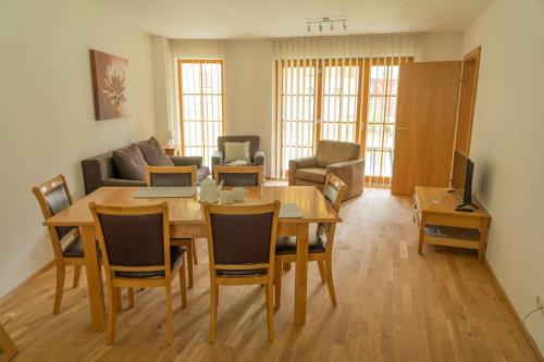 a living room with a table and chairs and a couch at Andrea 3 by SMR Luxury Apartments inc Spa and near Gondola in Rauris