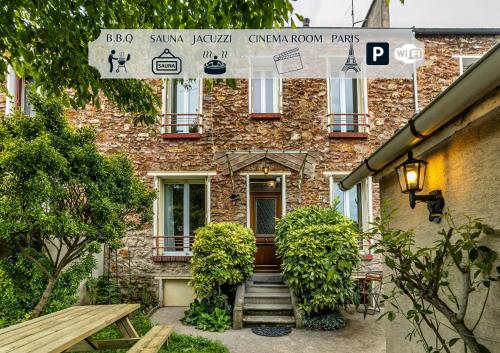 a brick house with stairs leading to the front door at La Maison l Expérience - Cinéma Spa Proche Paris in Maisons-Alfort