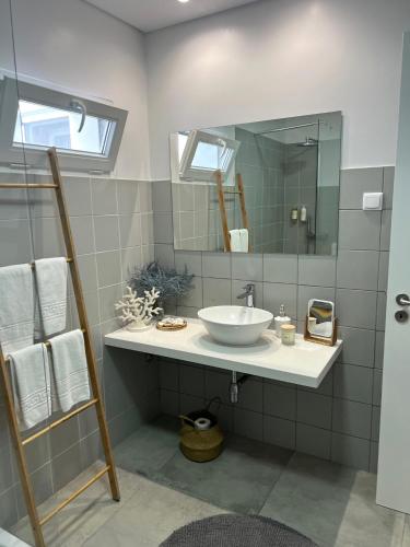 a bathroom with a sink and a mirror at Toi et Moi-Guests speek for us! in Ponta Delgada