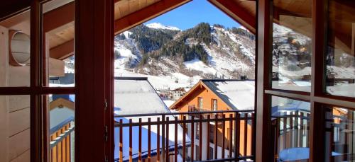 a view of a snowy mountain from a window at Martina 7 by SMR Rauris Apartments - inc Spa and near Gondola in Rauris