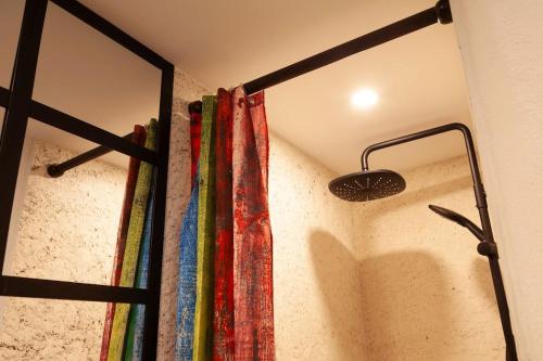 a room with a wall with colorful curtains and a light at Latelier DArtistes : expérience créative in Vierzon