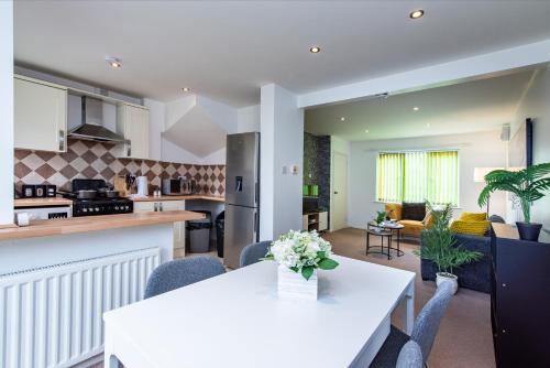 a kitchen and living room with a table and chairs at Comfortable 3-Bedroom House with Private Driveway in Bedford in Bedford
