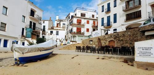 a boat sitting in the middle of a street with buildings at Calella Port Bo - Sea Sand Sun in Calella de Palafrugell