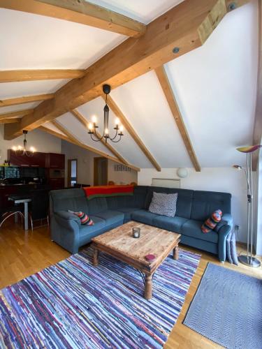 a living room with a blue couch and a table at Isabella 5 in Rauris