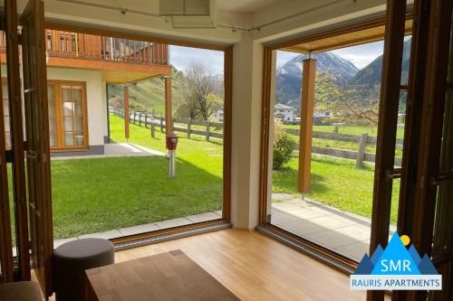 a sliding glass door with a view of a yard at Isabella 2 by SMR Rauris Apartments - inc Spa and near Gondola in Rauris