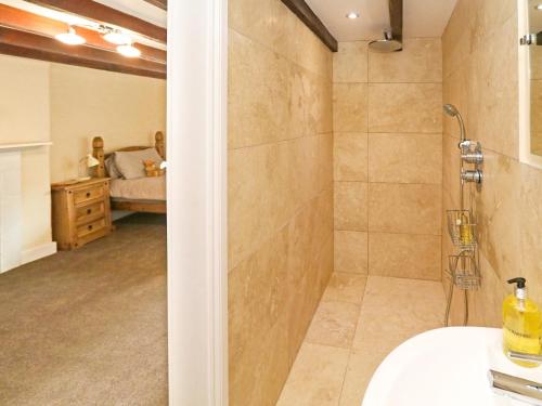 a bathroom with a shower and a sink and a bedroom at 2 Bed in Warkworth CN004 in Warkworth