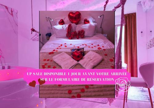 a bedroom with a bed with red roses on it at La Rêverie - Jacuzzi Lounge & Massage in Vierzon