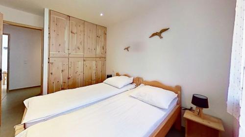 - une chambre avec 2 lits et un oiseau sur le mur dans l'établissement CASA-Bruno family chalet Queyras 7p, à Aiguilles