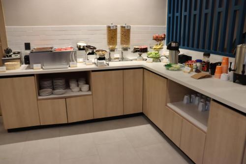 a kitchen with a counter with food on it at Quality Inn Piedras Negras in Piedras Negras