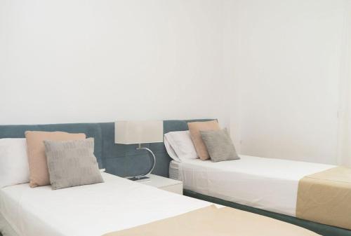 a bedroom with two beds and a lamp at Exclusivo Atico en La Cala Golf in La Cala de Mijas
