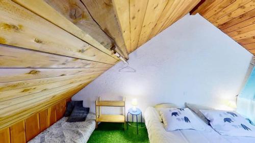 a small bedroom with a bed and a table and a chair at CASA-La Lorraine lovely studio in a chalet St-Véran 4p in La Chalp-Sainte-Agathe