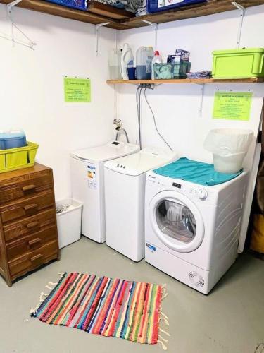 a laundry room with a washing machine and a washer at CASA-La Lorraine lovely studio in a chalet St-Véran 4p in La Chalp-Sainte-Agathe