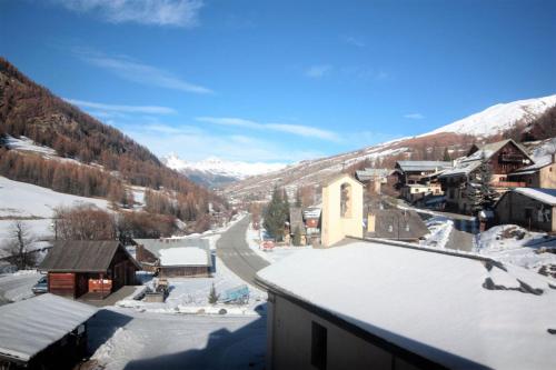 a view of a snow covered village in the mountains at CASA-La Lorraine lovely studio in a chalet St-Véran 4p in La Chalp-Sainte-Agathe