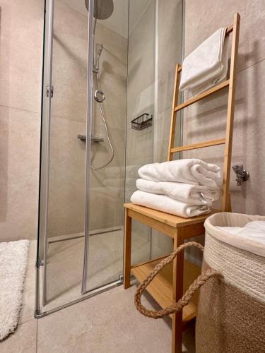 a bathroom with a shower with a ladder and towels at Moderne Ruheoase mit Balkon in Vienna