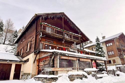 a large wooden building with snow on it at Casa-La Carotto Appartement pour 6 dans chalet in Saint-Véran