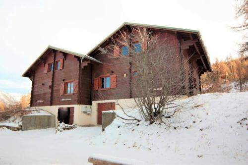 a large wooden house with snow on the ground at CASA Les Heureux Magnifique CHALET 6 chambres à RISOUL in Risoul