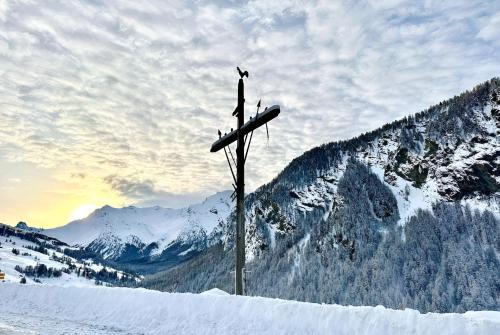 a pair of skis on top of a snow covered mountain at CASA-La Lobio foot of the slopes breathtaking views 4p in Saint-Véran