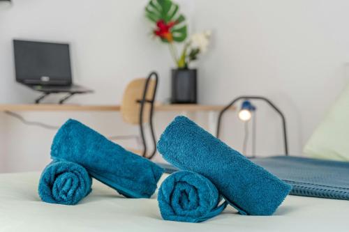 a pair of blue towels sitting on top of a bed at T2 Confort Lyonnais Métro République Garage fermé in Villeurbanne