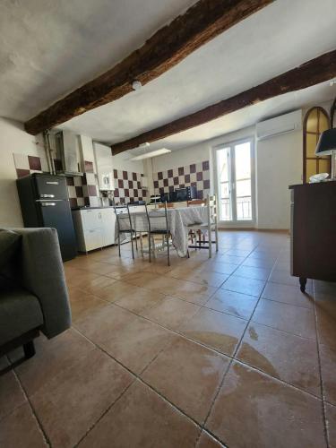 une cuisine avec une table et des chaises dans une pièce dans l'établissement Maison de village provençale, à Allemagne-en-Provence