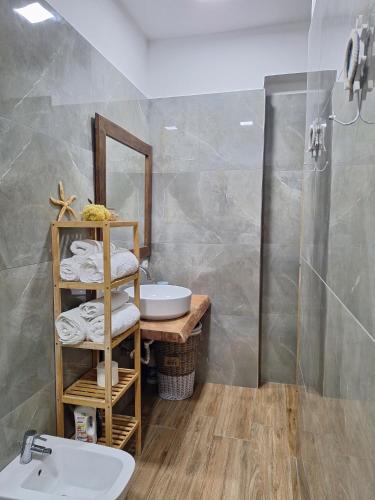 a bathroom with a sink and a mirror at DeJon Apartment in Gjilek