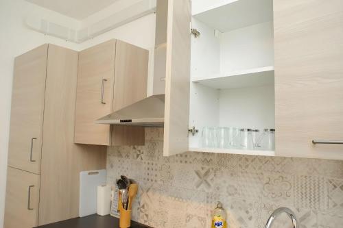 a kitchen with white cabinets and a sink at Grand T2 proche Créteil Soleil et métro ! in Créteil