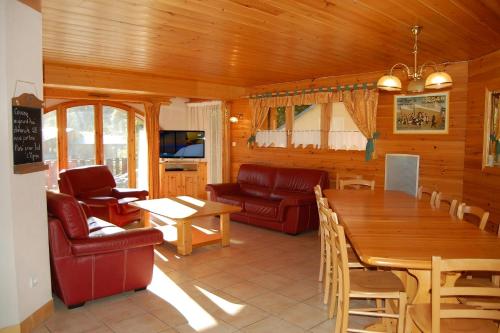 a living room with a table and a dining room at Casa-Chalet du Merle N° 1 in Champagny-en-Vanoise