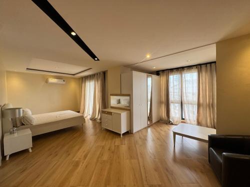 a large room with a bed and a table in it at Bel appartement F4 in Dakar